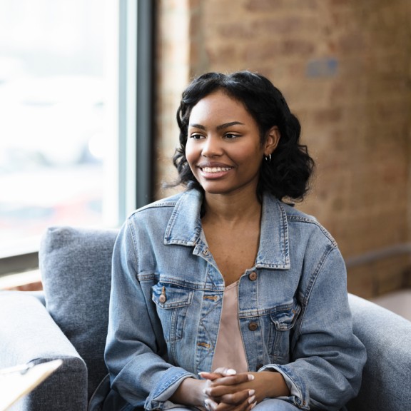 teen girl smiling and talking to adult