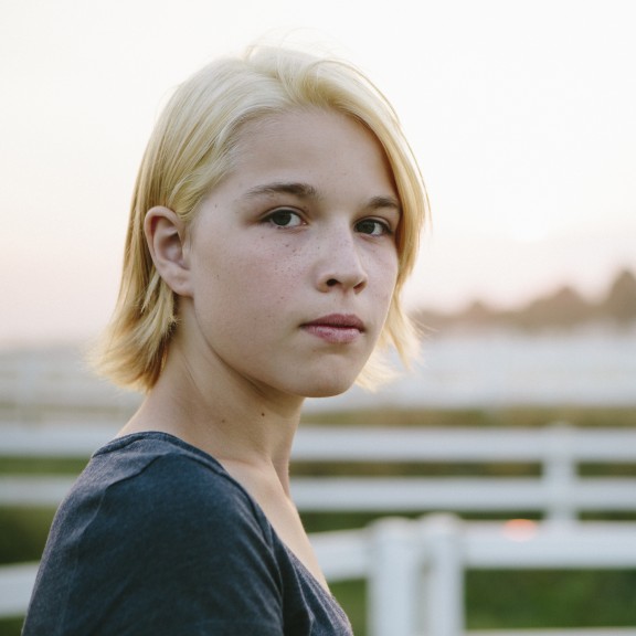 Young person standing in a pasture