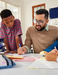 Students going over lesson with teacher